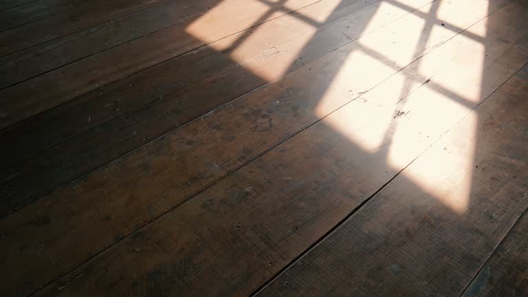 sunshine through windows with shadows on wooden floor old