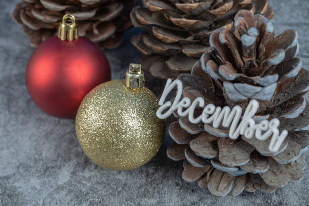 istock Christmas tree cone with december writing on it and glittering figures around 1302898785