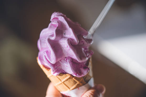 istock Hand holding dragon fruit soft serve ice cream. Nutritious and delicious tropical fruit ice cream. 1302899444