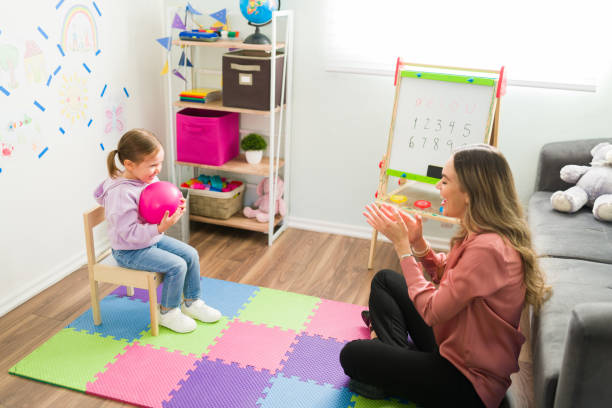 istock Happy psychologist having a therapy session with a child 1302900683