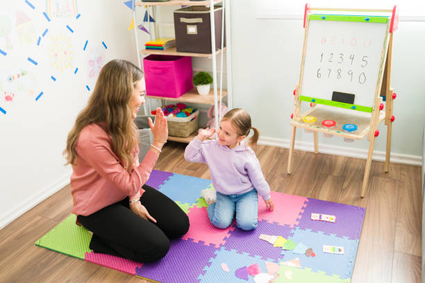 istock Smart preschooler finishing a puzzle sequence with her mom 1302900754