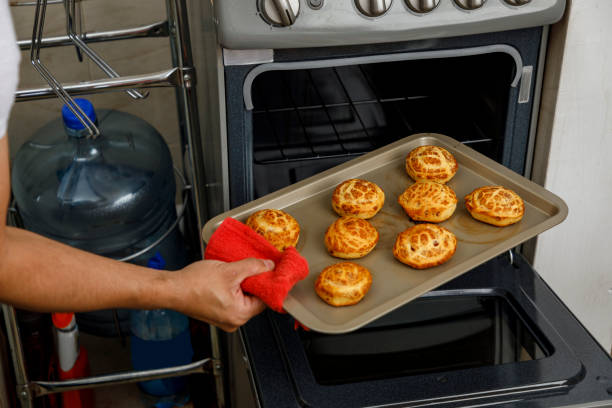 istock Freshly baked biscuits or traditional Mexican sweet bread, on a tray while being removed from the oven. Home baking concept, Mexican cuisine 1302901292