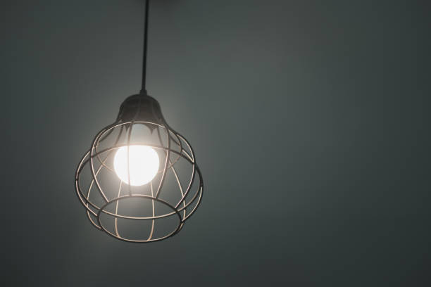 istock Modern pendant light with vintage light bulb decoration in home 1302901340