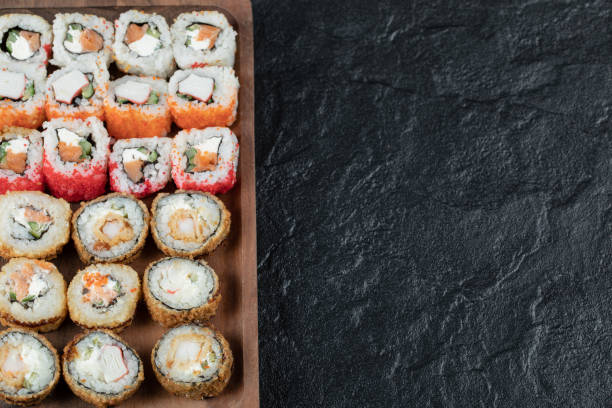 istock Hot sushi set on a wooden board with mixed ingredients 1302902361