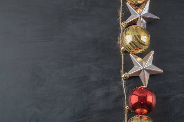 istock Colorful ornaments hanged from the rustic thread on the dark stone background 1302902688