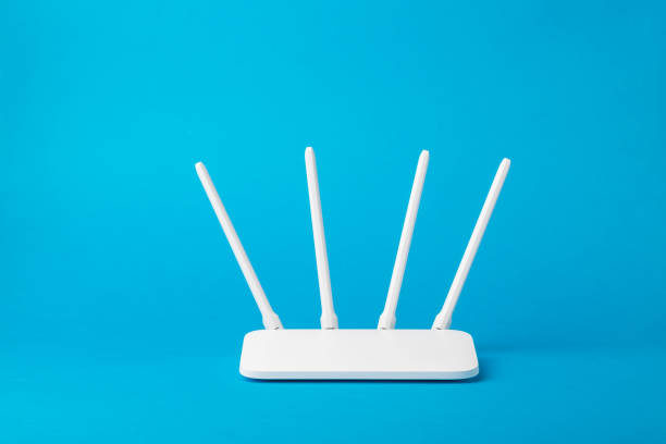 Wi-Fi router with four white antennas on a blue background. Wi-Fi router with four white antennas on a blue background. Organization of wireless networks. digital subscriber line stock pictures, royalty-free photos & images