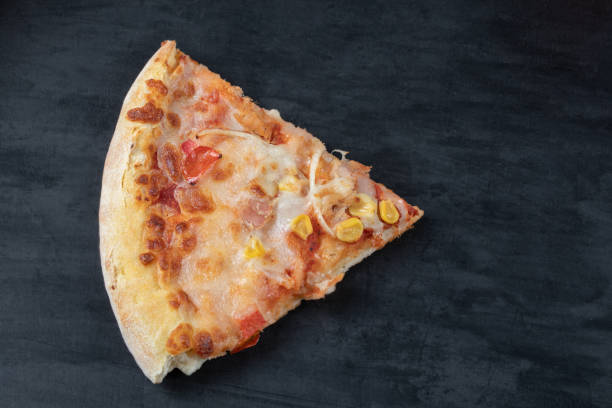 istock A slice of margarita pizza on a black background 1302905912