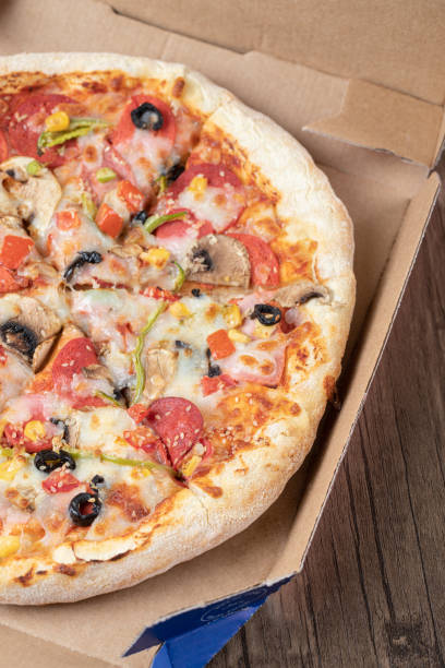 istock Pepperoni pizza with black olives in a cardboard takeaway box 1302906665