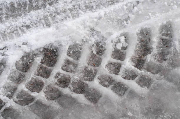 istock tire tracks in frozen snow on a road 1302906828