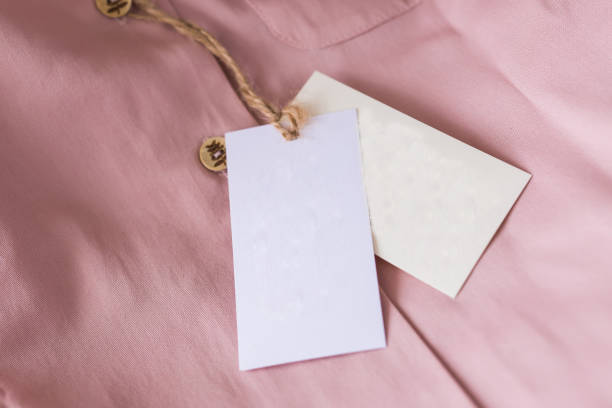 istock Close-up blank tag label on pink shirt. Copy space. space for advertisement. 1302907501
