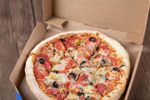 istock Pepperoni pizza with black olives in a cardboard takeaway box 1302908342