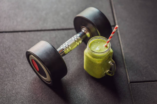 Green smoothies and dumbbells in the gym