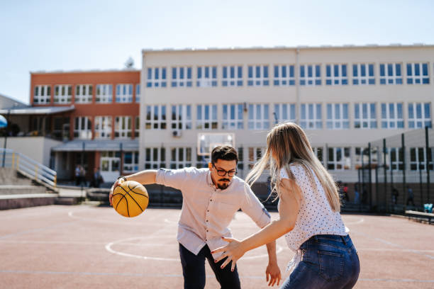 istock Young couple playing basketball 1302917921