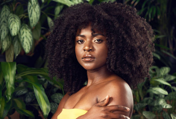 Shot of a beautiful young woman posing against a leafy background