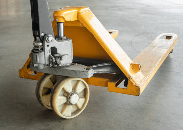 istock Yellow hand pallet truck or hand pallet jack forklift. work tools unloading the warehouse. 1302918230
