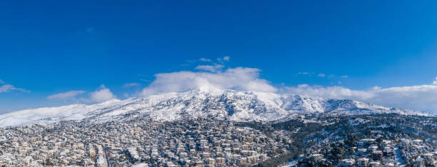 istock Attica Greece. Penteli mountain covered with snow, aerial drone view, blue sky background 1302919458