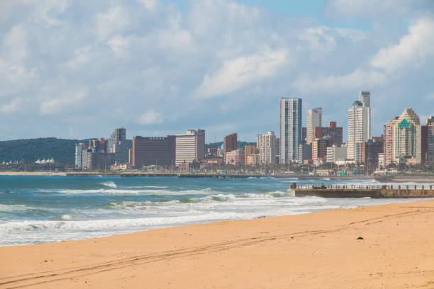 istock Beach with Pier and Tall Buildings and Bluff in Background 1302920088
