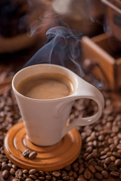 istock cup of coffee and coffee beans in a sack on dark background, top view 1302920142