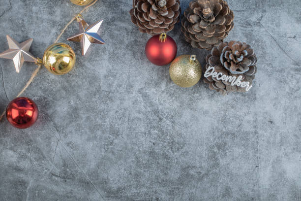 istock Christmas tree cone with december writing on it and glittering figures around 1302920309