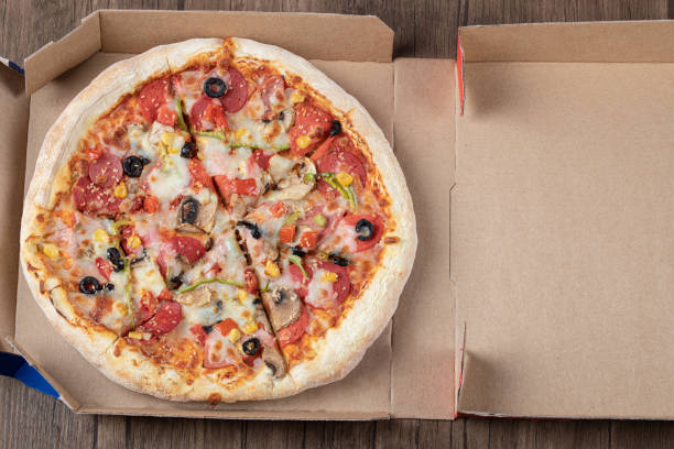 istock Pepperoni pizza with black olives in a cardboard takeaway box 1302921216