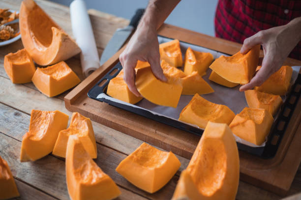 istock Preparing pumpkin for oven roasting, close-up 1302922276