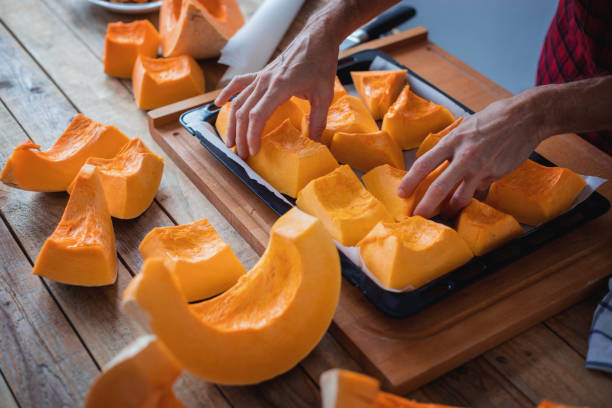 istock Preparing pumpkin for oven roasting, close-up 1302922349