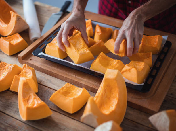istock Preparing pumpkin for oven roasting, close-up 1302922353