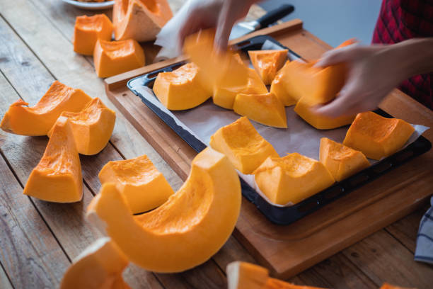 istock Preparing pumpkin for oven roasting, close-up 1302922435