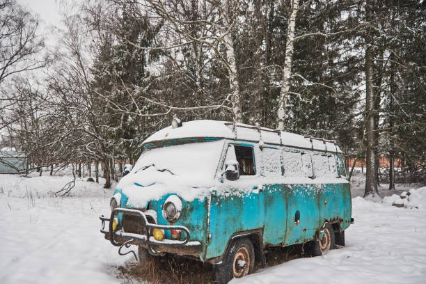 istock An old rusty ambulance van stands in a snow-covered clearing on a cloudy winter day. 1302922513