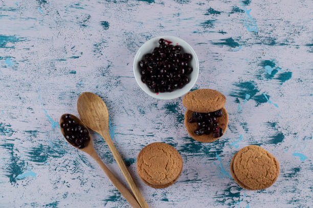istock Crispy oatmeal cookies with blackcurrant berry confiture on it 1302924140