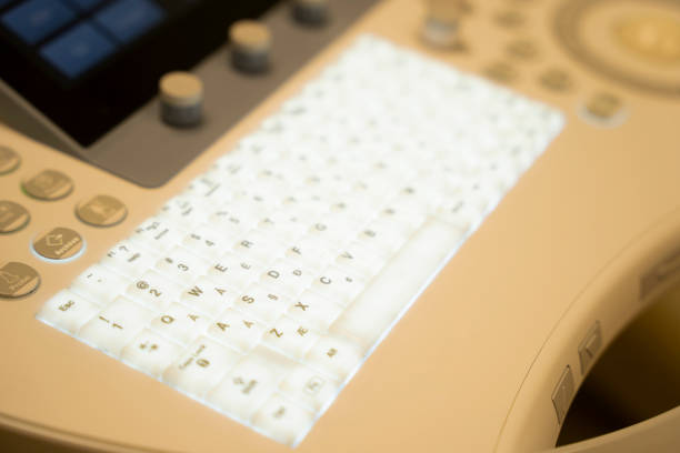 istock Close up on the illuminated key on the keyboard of a sonogram machine. 1302924722