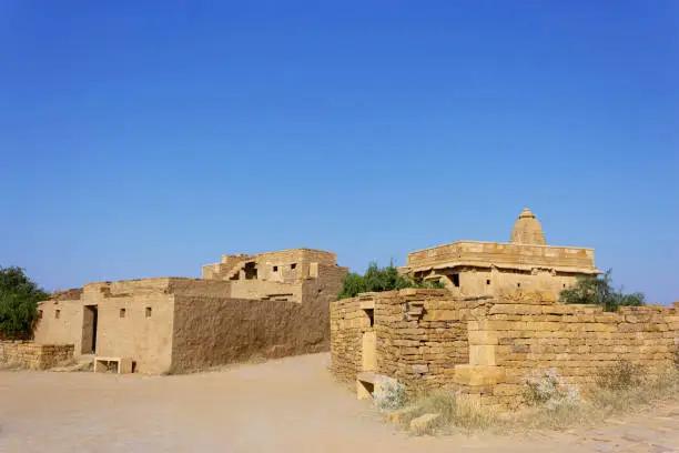 Old house and temple view of Kuldhara an abandoned village, Jaisalmer Rajasthan, India. Established in 13th century inhabited by Paliwal Brahmins.