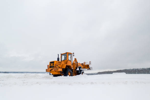 istock Snow clearing. Tractor clears the way after heavy snowfall. 1302925714