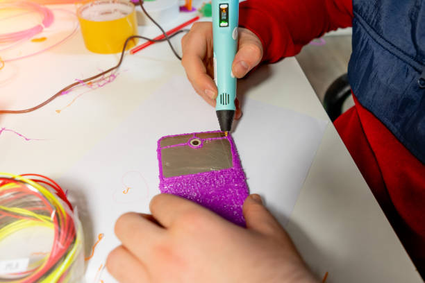 istock Boy using 3D pen. Happy child making flower from colored ABS plastic. Creative hobby at home, technology, leisure, education concept. 1302926696