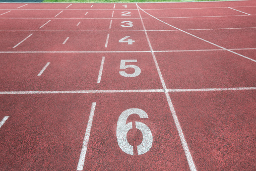athletics background image with finish line on red sport cinder track