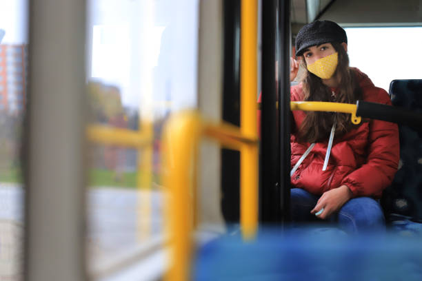 istock Girl with a mask using the public transport 1302928182