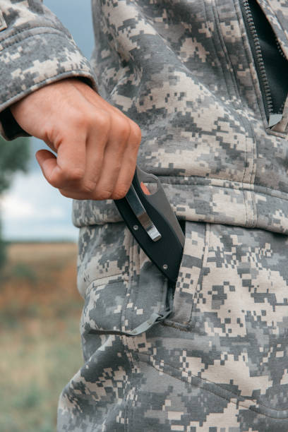 istock A man with a knife in the forest 1302928888