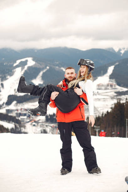 istock Winter snow couple in a mountains 1302929216