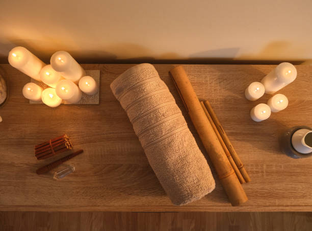 istock spa towel, bamboo sticks and candles. overhead view 1302933086