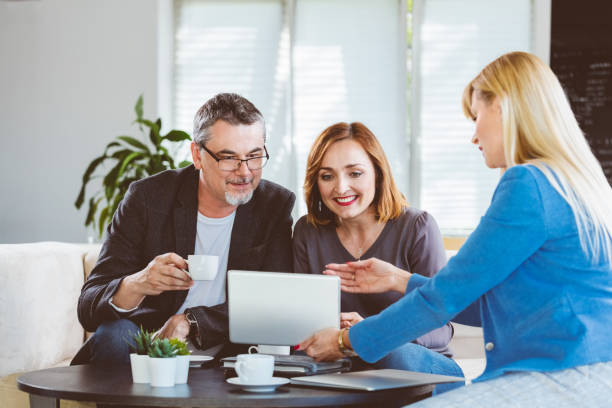 istock Mature couple talking with financial advisor 1302934533