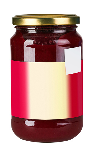 Glass preserve jar of rasperry jam  with blank label on a white background