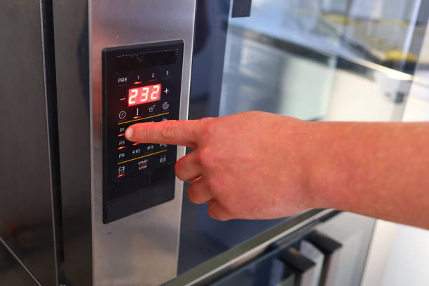 istock Hand turns on the equipment in the bakery 1302938116