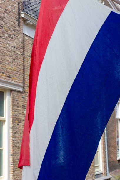 istock Dutch flag hanging from a building in the Netherlands 1302938848