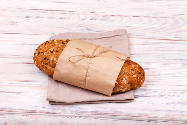 istock Loaf of fresh bread on white background. Ecological food 1302938976