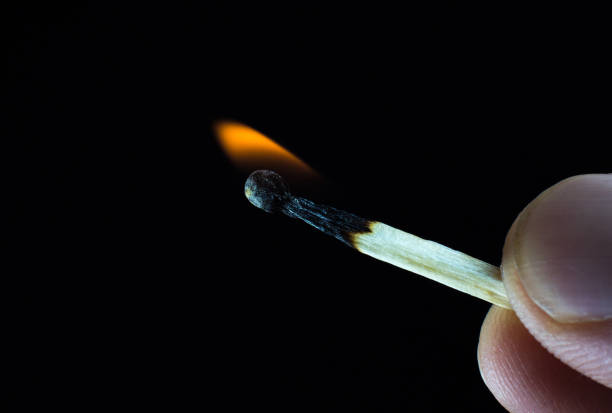 istock Burning match in a man's hand. New idea concept. 1302939143
