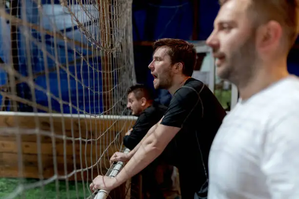 Amateur indoor soccer players cheering for teammates