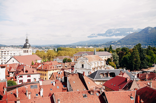 Annecy city top view, lake in the distance. Tile roofs, Cathedral. High quality photo