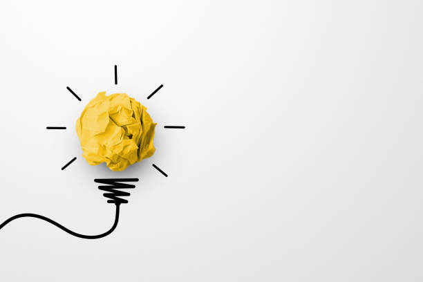 istock Creative thinking ideas and innovation concept. Paper scrap ball yellow colour with light bulb symbol on white background 1302940744