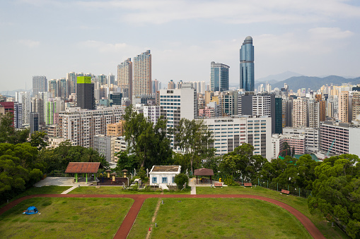 Aerial view of a public park with a jogging track on the top of a hill in the very crowded Yau Ma Tei district in Kowloon, Hong Kong