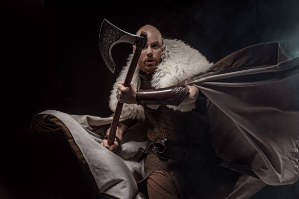 istock Weapon wielding viking warrior in studio moving action shot 1302941627